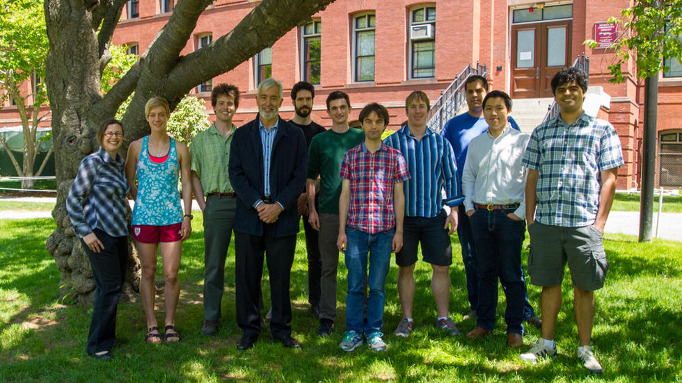 11 Farrell Lab members standing under tree, in front of Harvard MCZ