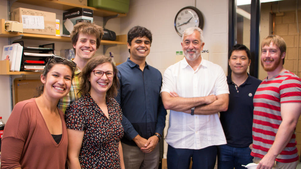 7 Farrell Lab members standing on front of corner of room