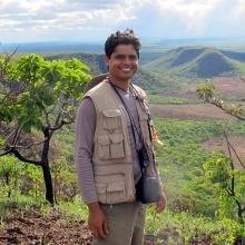 Bruno A. Souza de Medeiros standing in front of lush mountains