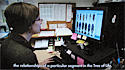 Screenshot of video, showing Amie Jones at computer, with images of beetles on screen